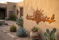 Rusted steel quail family sunset wall art on a stucco wall
