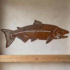 Rusted steel trout wall art on an interior wall
