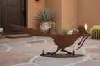 Rusted metal roadrunner sculpture, running pose