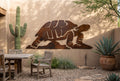 Rusted steel desert tortoise wall art on an adobe patio wall